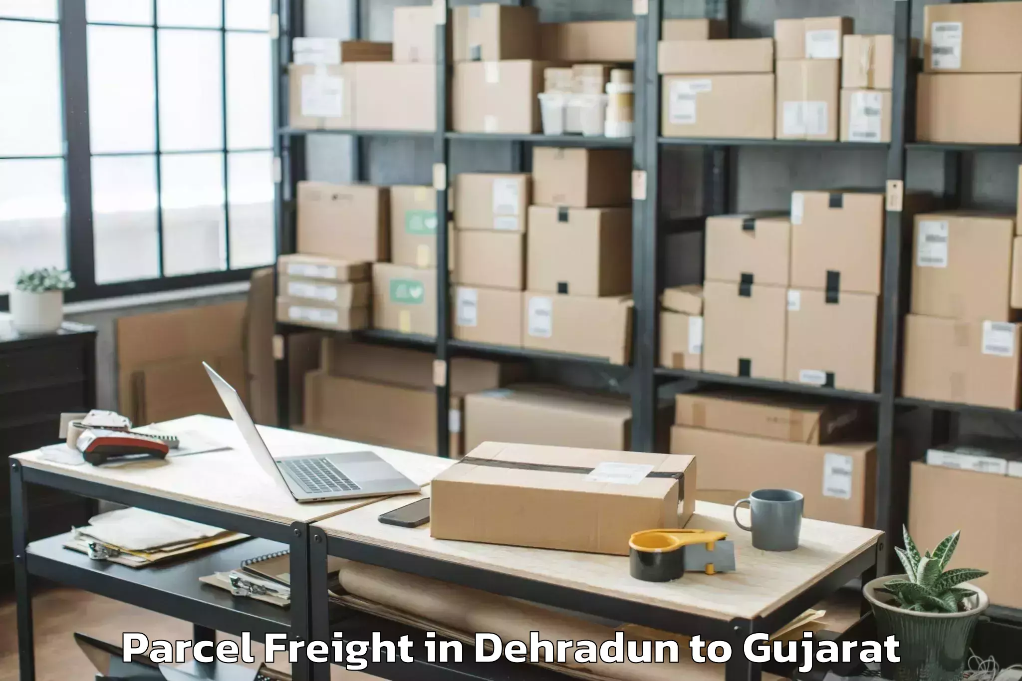 Book Dehradun to Dholka Parcel Freight Online